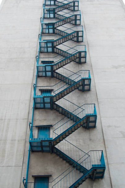 Industrial metal staircase with yellow railings in a chemical factory