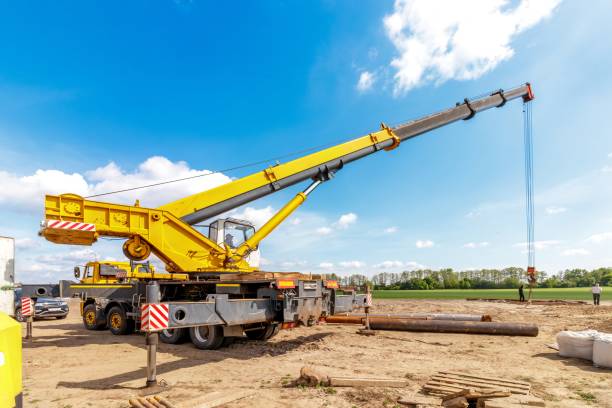 istock A construction site with a lifting crane and workers installing water pipes. 2162519578