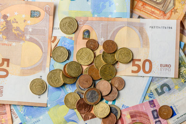 istock Euro bills and coins scattered on the table as a background 18 2162524377