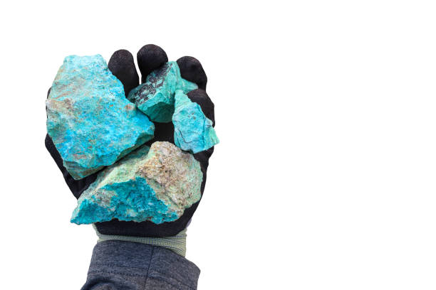 istock Blue green copper (Cu) oxide ore, held in hand with protective glove. White background. Mining. 2162525035