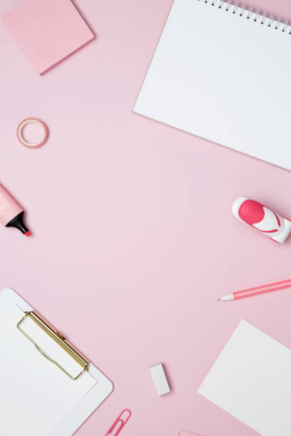 istock Creative flat lay mockup design of workspace. Top view composition with white notebook, to do list and stationery on pink background 2162526378