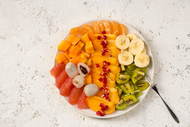 istock A large plate with various tropical fruits on a light background 2162527674