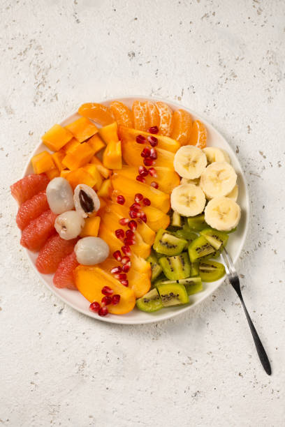istock A large plate with  tropical fruits on a light background 2162527711