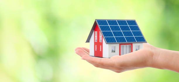 istock Hand Holding an Energy-Efficient Model House with Solar Panels 2162530601