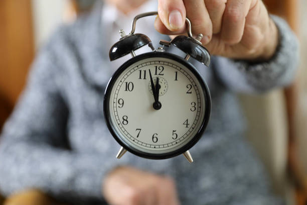 istock An elderly man holding an alarm clock. 2162530759