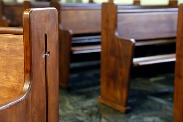 istock wooden benches inside a church 2162535437
