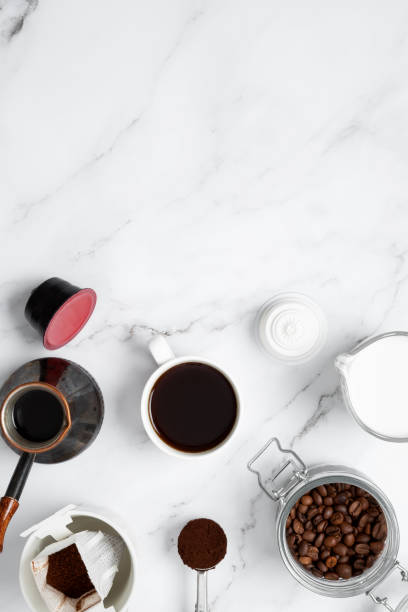 istock Ingredients for making coffee. Different ways to make coffee metal cezve, coffee machine capsules, drip and milk. Coffee making concept. Flat Lay. Top view. Copy space 2162535478