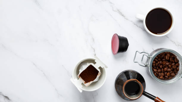 istock Ingredients for making coffee. Different ways to make coffee  metal cezve, coffee machine capsules, drip. Coffee making concept. Flat Lay. Top view. Copy space 2162535481