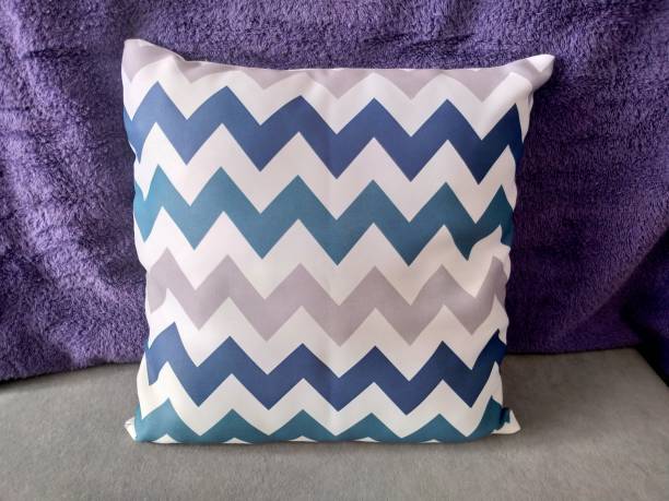 istock Blue and gray chevron pattern throw pillow on a purple background. 2162536687