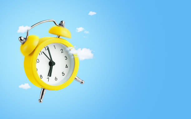 istock Yellow alarm clock on. blue background. 2162544070