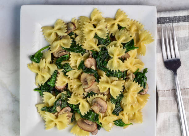istock farfalle pasta with  spinach and mushrooms 2162545413