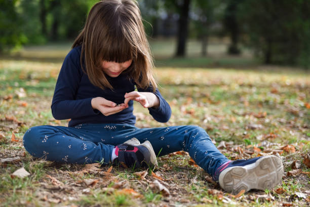 Cute little girl playing in autumn park