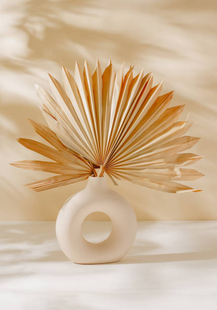 istock Beautiful ceramic vase with palm leaf and aesthetic sunlight shadows. 2162549404