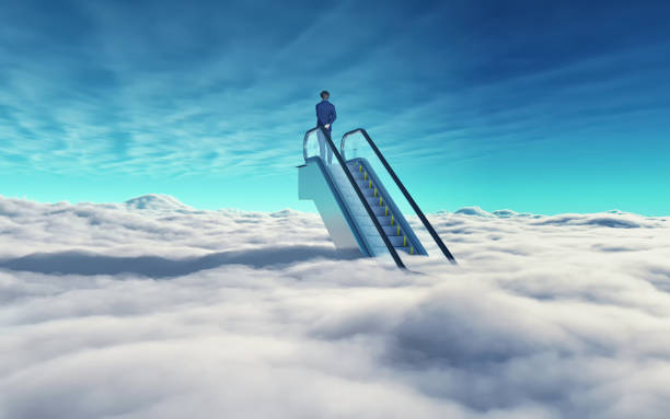 Man on top of escalators above clouds in the sky.