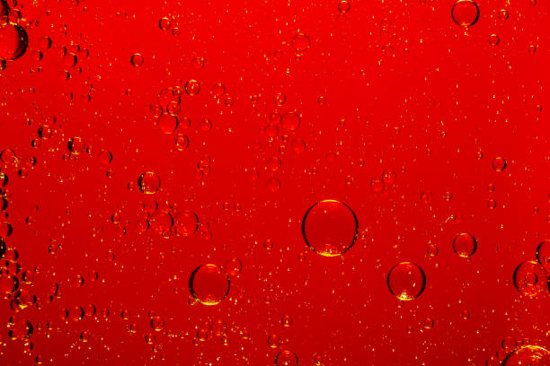 istock Macro red bubble texture close-up,red macro bubbles,Backgrounds, Abstract Backgrounds, Soda, Red, Carbonated,Beauty concept background. Closeup cosmetic liquid gel with bubbles on red colors background 2162551323