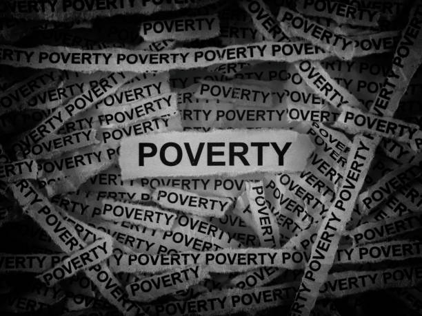 istock Strips of newspaper with the words Poverty typed on them 2162551996