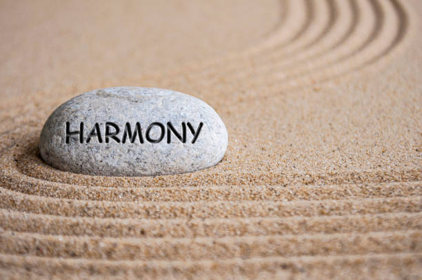 istock Harmony text engraved on Zen stone on sand. Peace and harmony concept 2162555582