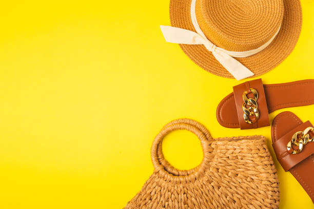 istock Beach bag, straw hat and sandals on a bright colored background. Beach object. Summer stylish fashionable bag. Beach accessories. Summer holiday concept.Place for text. Copy space.top view 2162560635