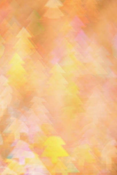 Abstract Festive Light with Christmas Tree Shapes, figured Bokeh as Soft Background, natural flare from lights, blurred texture as winter holidays backdrop, celebration photo with optical effect