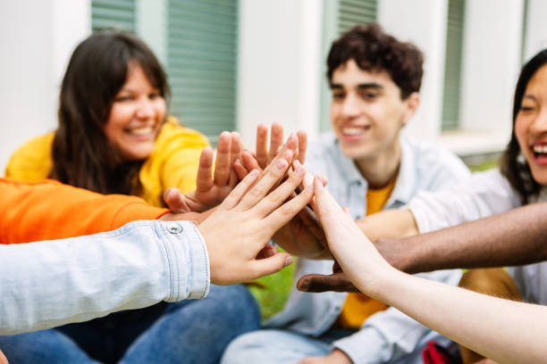 istock Diverse group of student friends joining hand showing unity and support. 2162562222