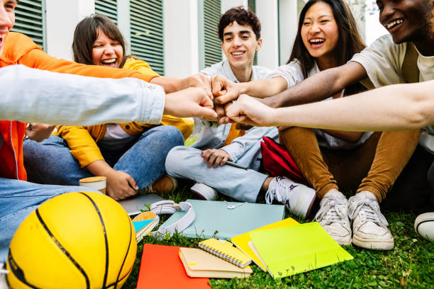 istock Group of college students joining hands showing support and cooperation 2162562315