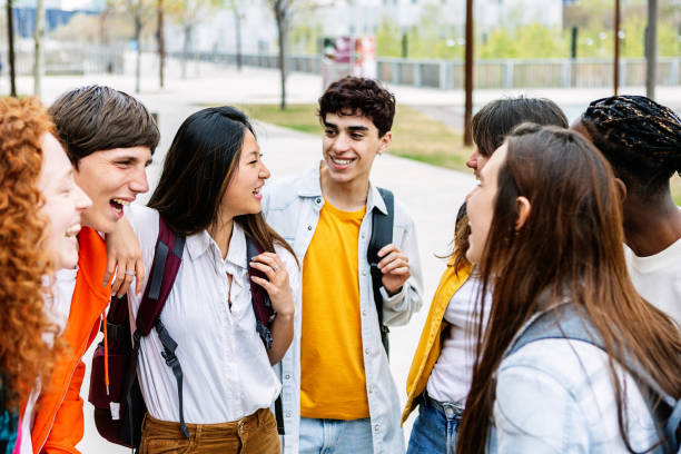 istock Diverse teenage student group having fun together talking at college campus 2162562397