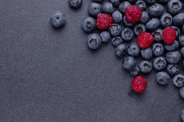 istock blueberries and raspberries on a blue background, a copy of the space 2162562683