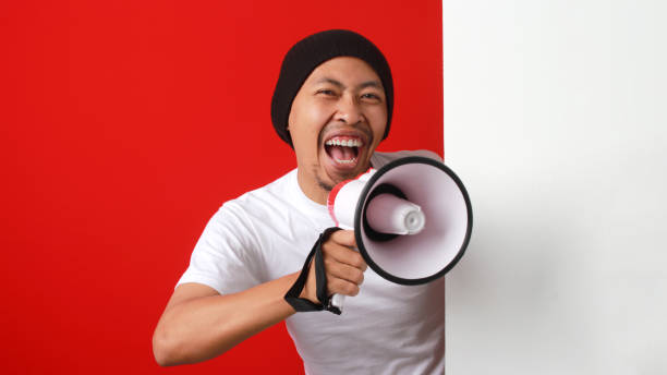 istock Enthusiastic Indonesian Man Announcing Independence Day Promo 2162562831