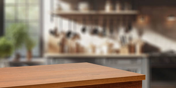 istock Wooden kitchen countertop with empty space for montage products and blurred bright kitchen interior with natural sunlight coming through the window. 2162565064