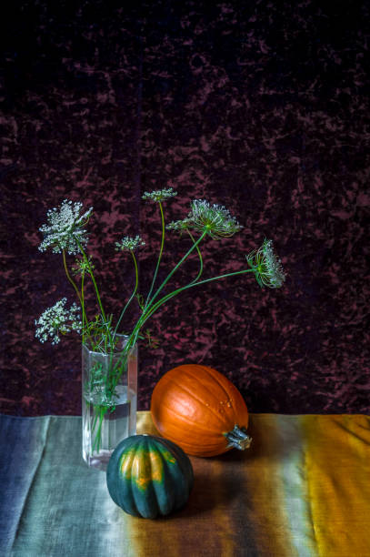 Still life with squash and vase with field flowers