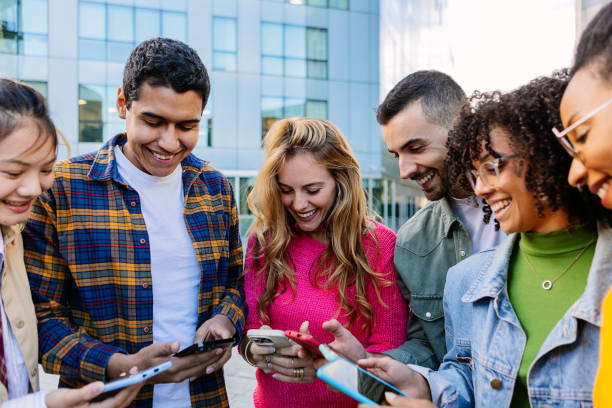 istock Young group of student friends using mobile phone at college campus 2162565493