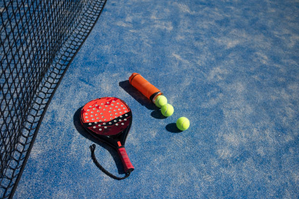 istock Paddle tennis objects: rackets and balls in court 2162565586