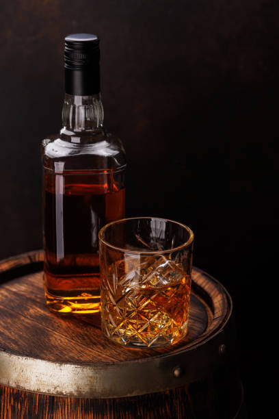 istock Whiskey glass with ice on a rustic barrel, a classic sip 2162568238