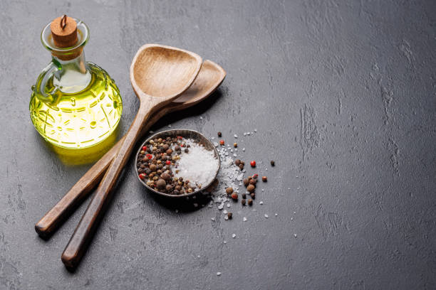 istock Spices, olive oil, and utensils on cooking table 2162568614