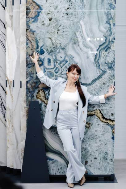 istock Woman posing in light blue suit against marble slab 2162572109