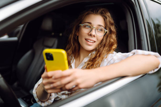 istock Woman driver using a smart phone in car. 2162575660
