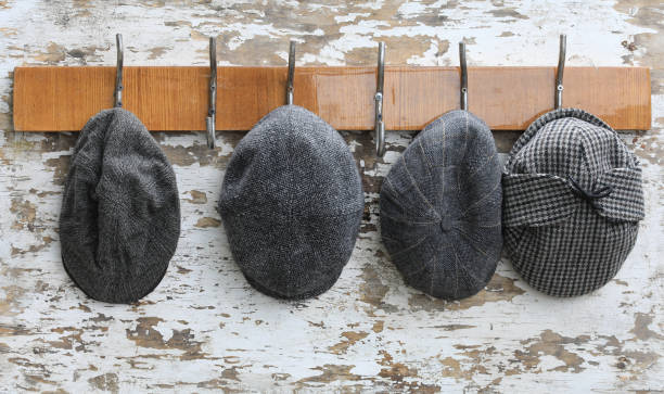 istock hanger with hooks with caps on an old wooden wall 2162576020