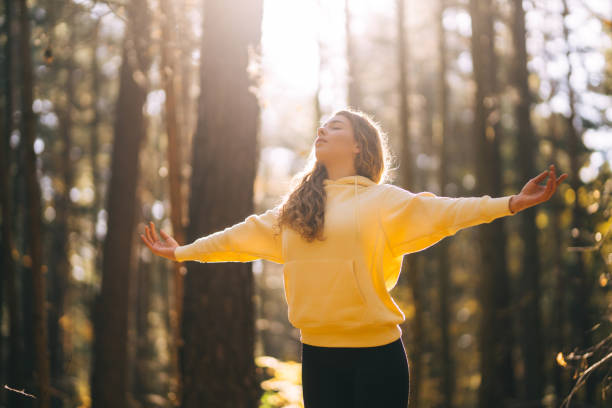 istock Young Woman doing yoga pose in peaceful natural forest. 2162576024