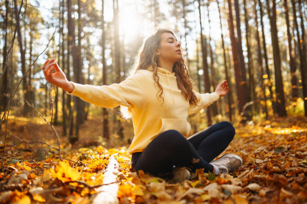 istock Young Woman doing yoga pose in peaceful natural forest. 2162576026
