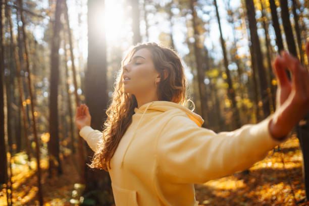 istock Young Woman doing yoga pose in peaceful natural forest. 2162576539