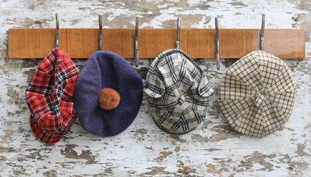 hanger with hooks with caps on an old wooden wall