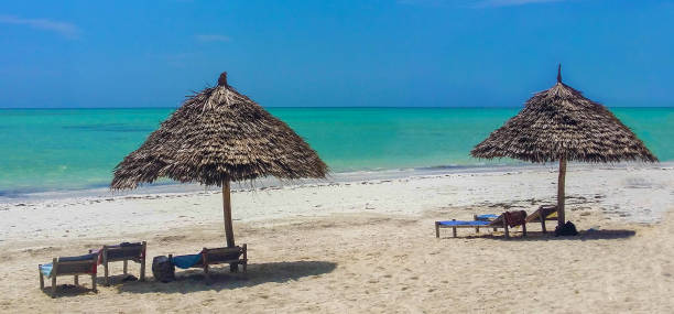 istock Sunny beach with a sun umbrella 2162577266