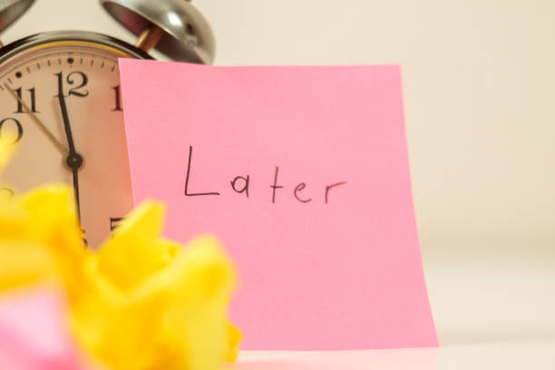 istock Procrastination: Close-up of an alarm clock and sticky notes, symbolizing procrastination 2162577679