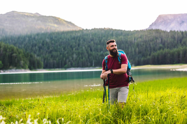 Happy Man Hiking by Mountain Lake