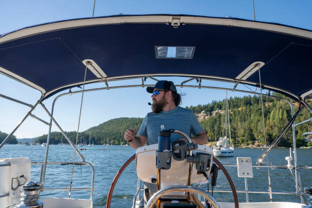 istock Portrait of captain steering boat 2162578889