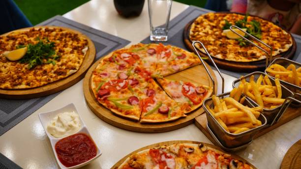 Delicious Pizza and Fries on a Table