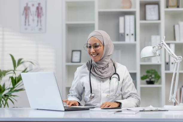 istock Smiling female doctor using laptop in modern office 2162585702