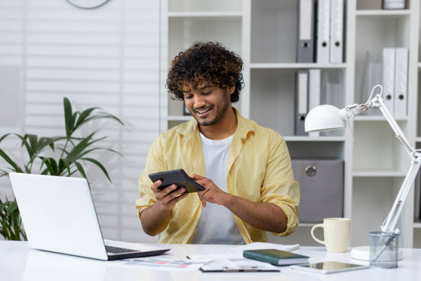 istock Man using calculator for paperwork in home office, focused on finances 2162586502