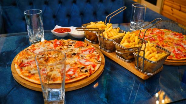 istock Pizza and Fries on a Restaurant Table 2162586765