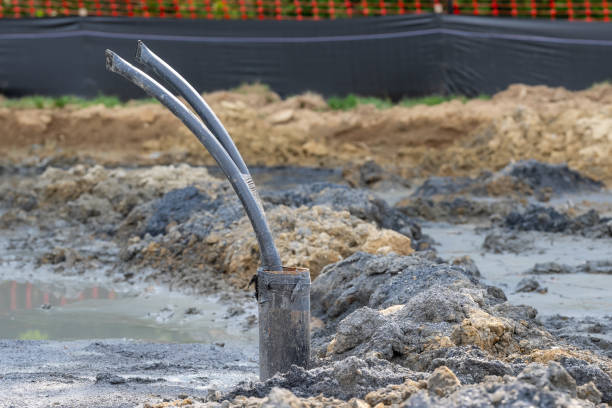 istock Casing pipe with polyethylene ground loop pipes in the process of being installed in a new geothermal well field. 2162588173